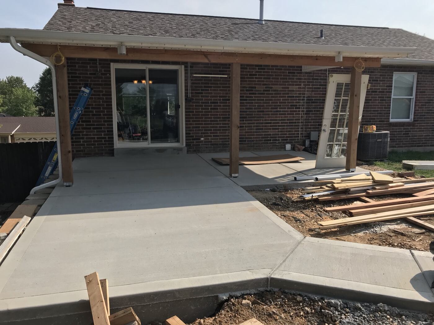 New covered concrete patio and deck construction